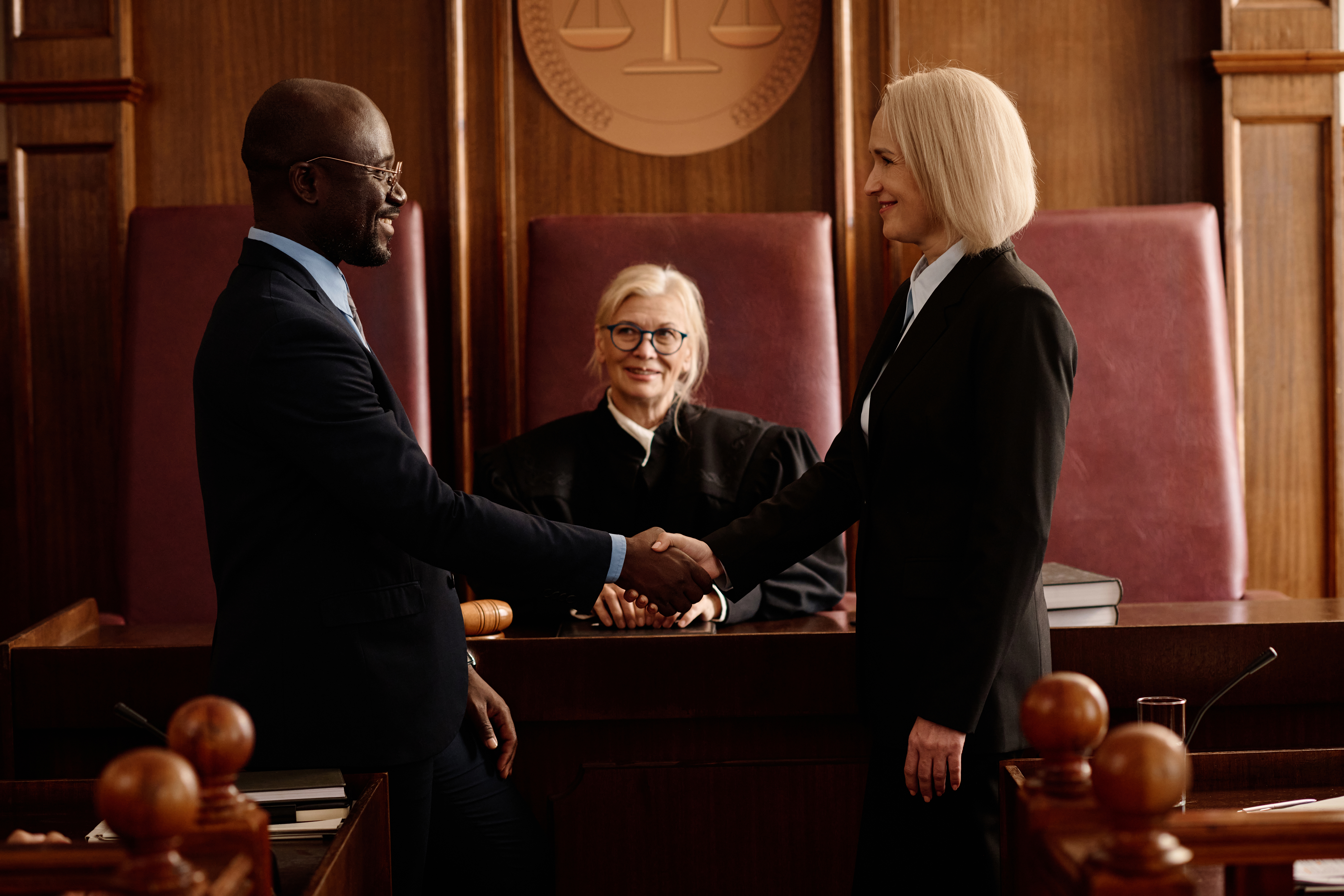 Prosecutor and attorney shaking hands after reaching an agreement